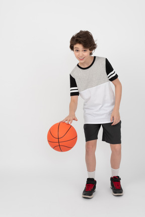 Boy hitting a basketball ball