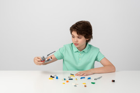 Teen boy playing with construction set