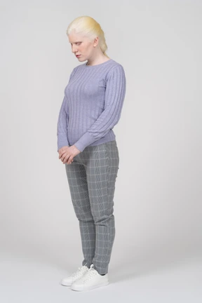 Three-quarter view of a young woman looking down