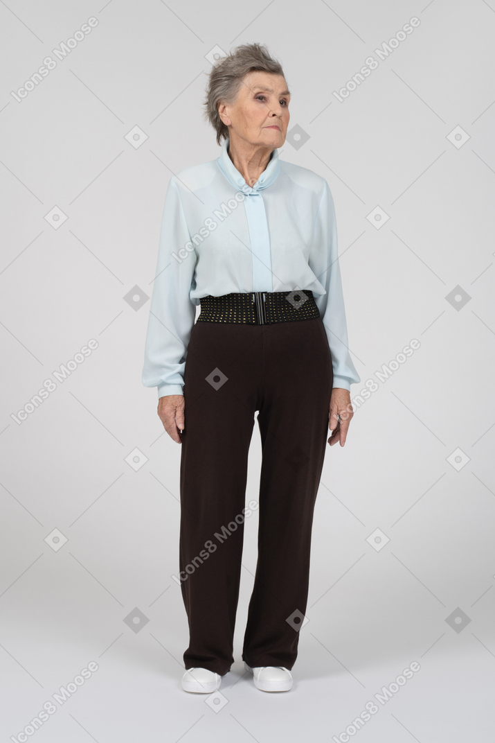 Old woman standing and looking down