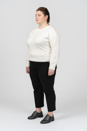 Plump woman in casual clothes standing