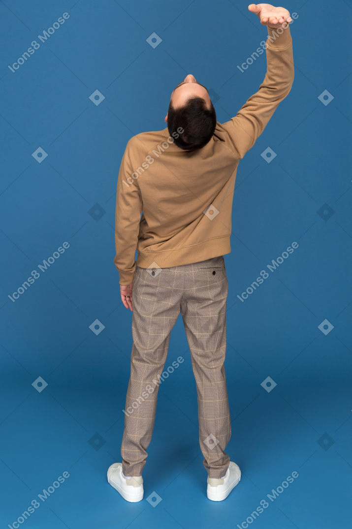 Young man touching the ceiling