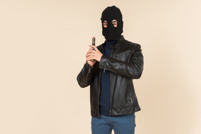 Man in balaclava holding a gun