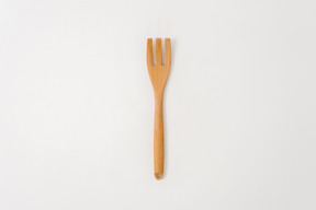 Wooden fork on white background