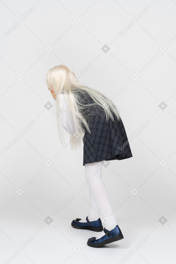 Back view of a schoolgirl bending forward