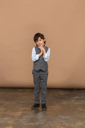Front view of a cute boy in grey suit