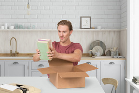 A man taking books out of a box