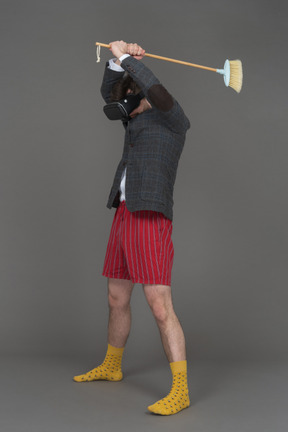 Man in vr headset with a broom