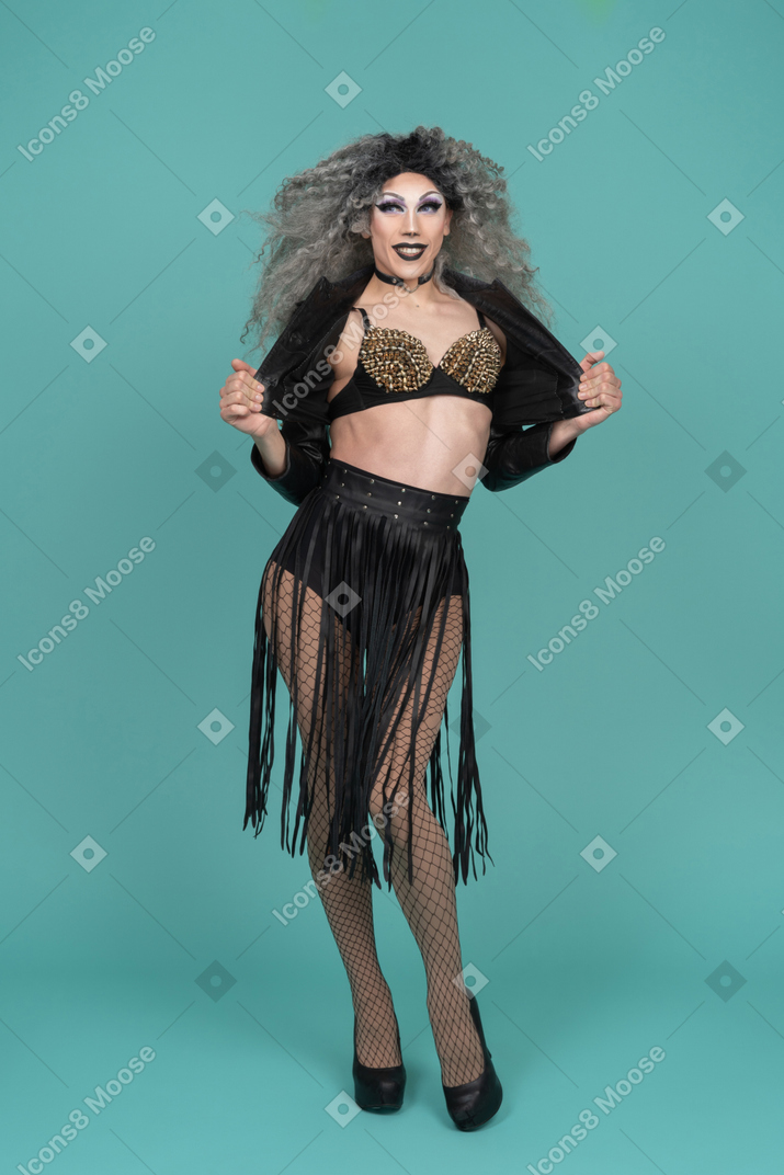 Drag queen opening their jacket and smiling