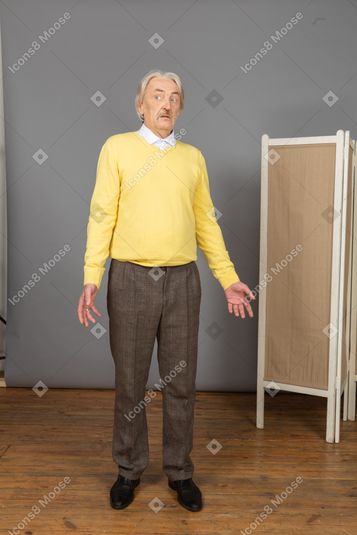 Front view of a questioning old man looking aside