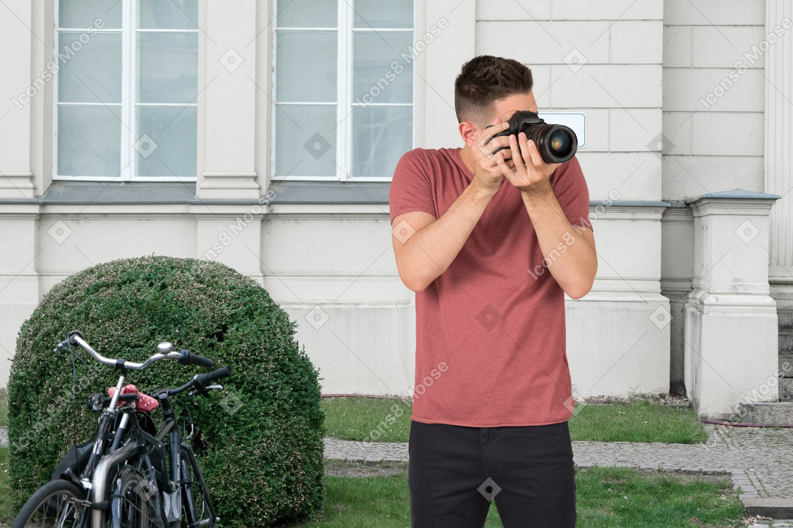 A man taking a picture with camera outside