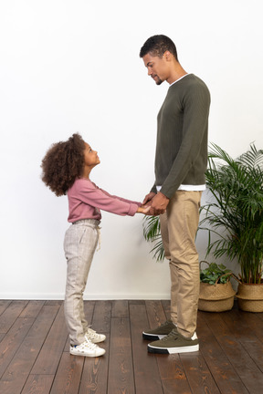 Father and daughter hold hands