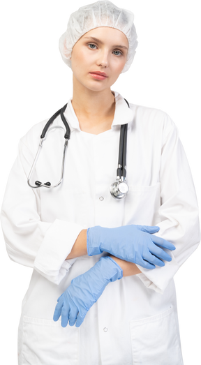 Front view of a tired young female doctor with stethoscope looking at camera