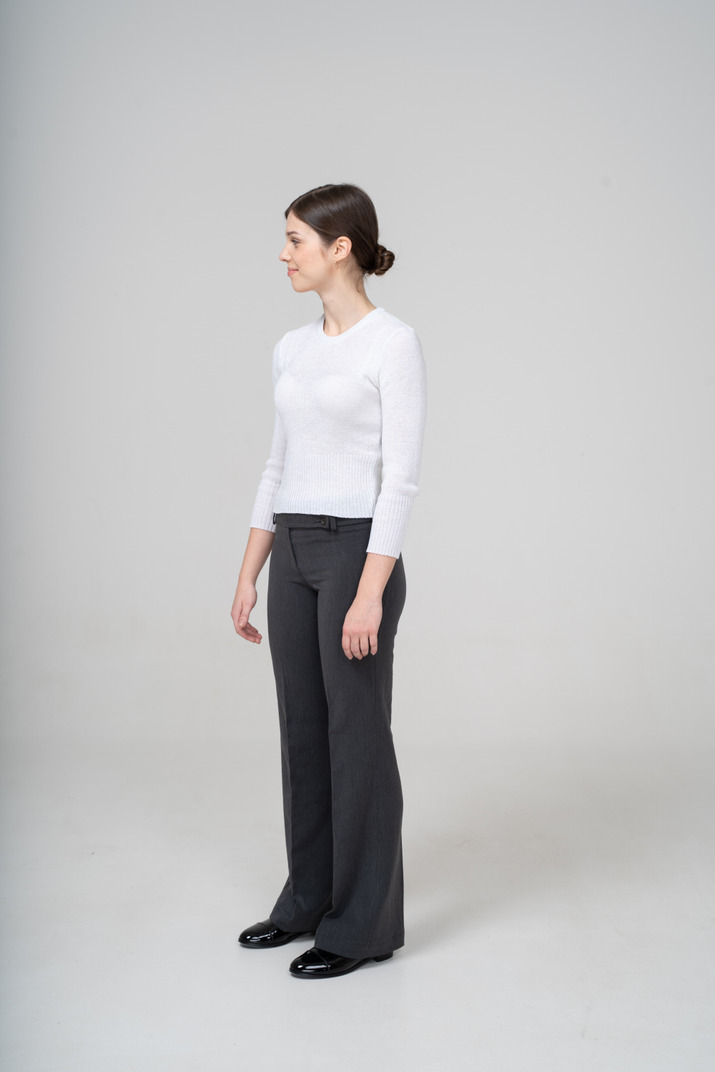 Front view of a woman in white blouse and black pants