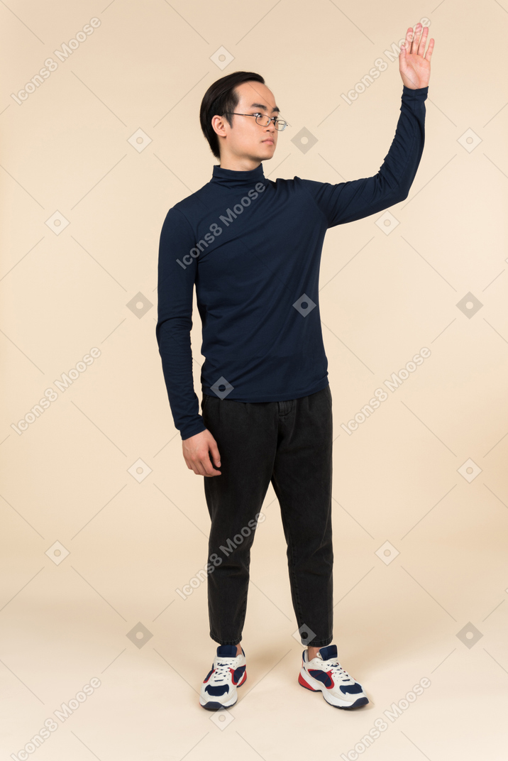 Young asian man waving