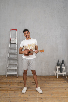 Front view of a man playing ukulele