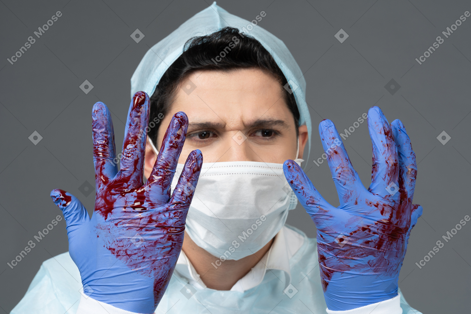 Doctor looking at his hands covered in blood