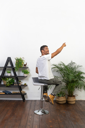 Good looking young man sitting on a chair