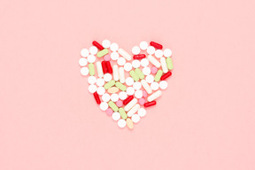 Multicolored pills arranged in a shape of heart