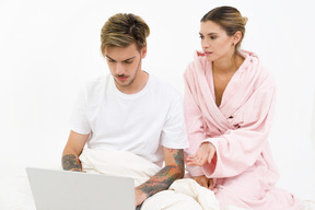 Good looking couple sitting in bed