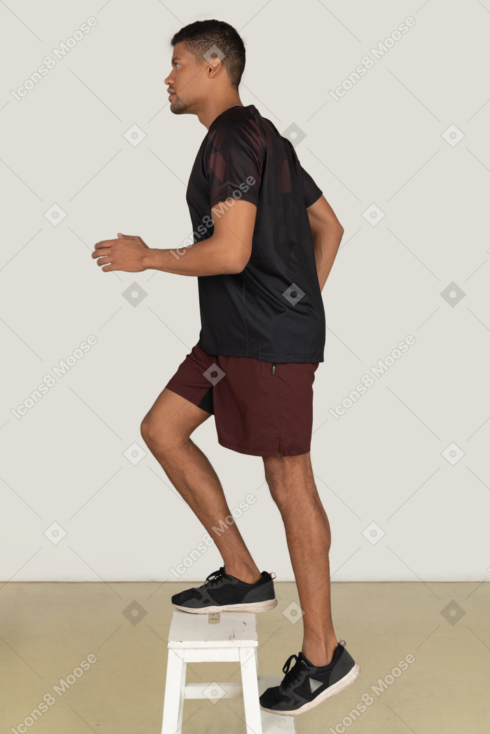 Young man in sports clothes exercising