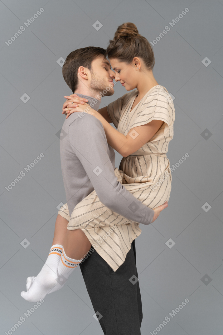Side view of a happy couple holding each other