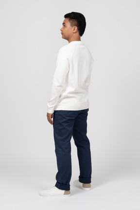 Back view of man in white longsleeve shirt and jeans