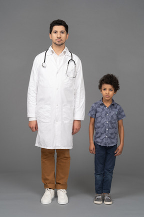 Doctor and boy standing still