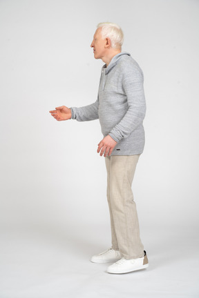 Side view of man reaching out his hand