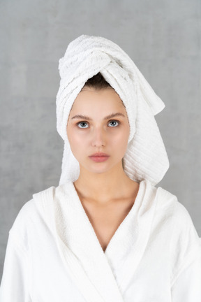 Portrait of a woman with hair towel wrapped around head