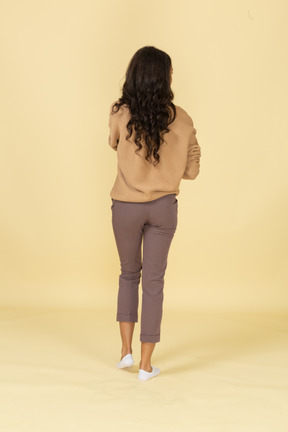 Back view of a dark-skinned young female