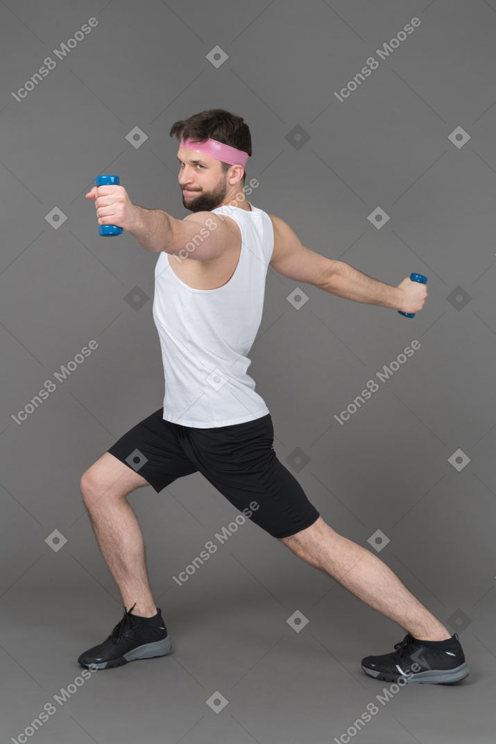 Sporty man doing sport with dumbbells