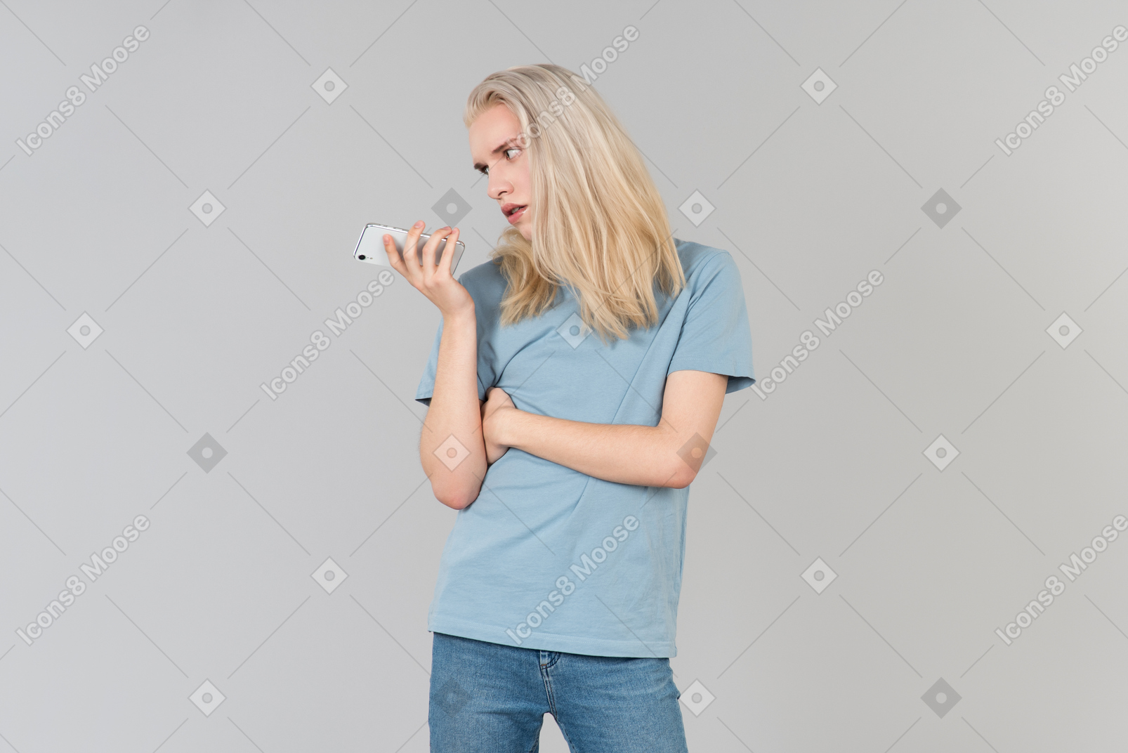 Sick and tired young guy with long hair holding smartphone