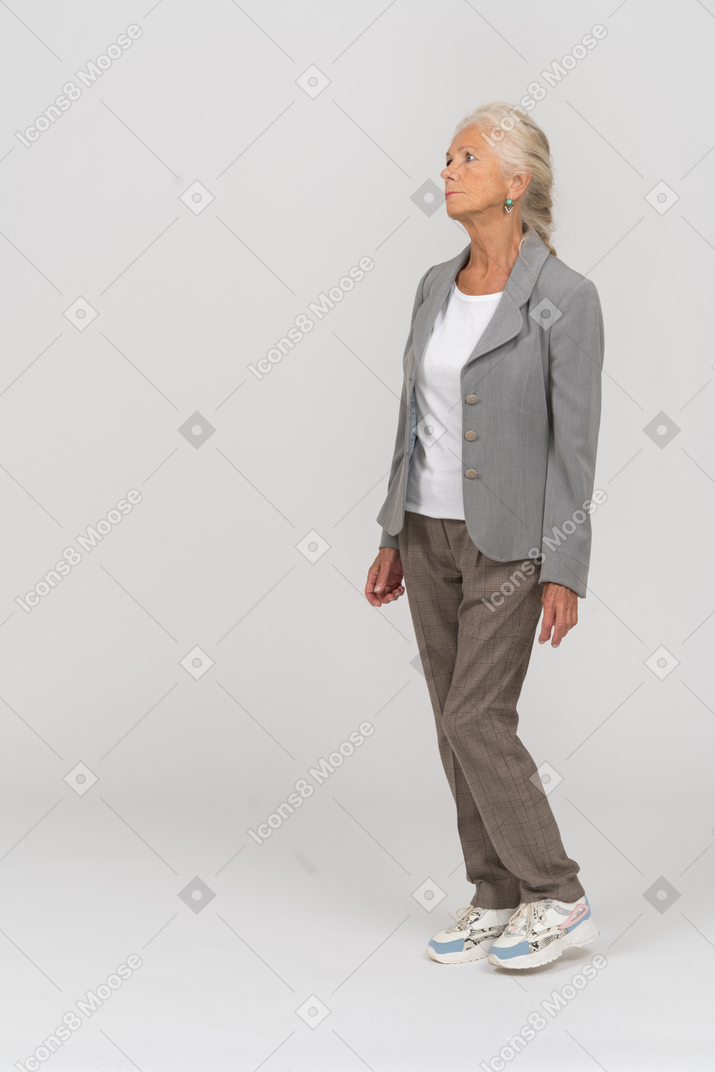 Side view of a thoughtful old woman in suit