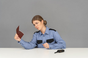 A female security guard checking a passport