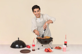 Young caucasian man preparing bbq