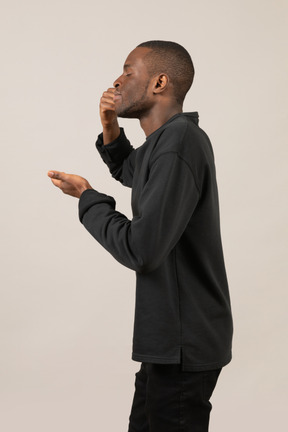 Side view of a man smelling something