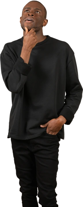 Young thinking man holding hand on chin