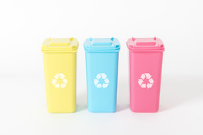Three colorful trash cans