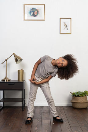 Good looking girl kid posing on the apartment background