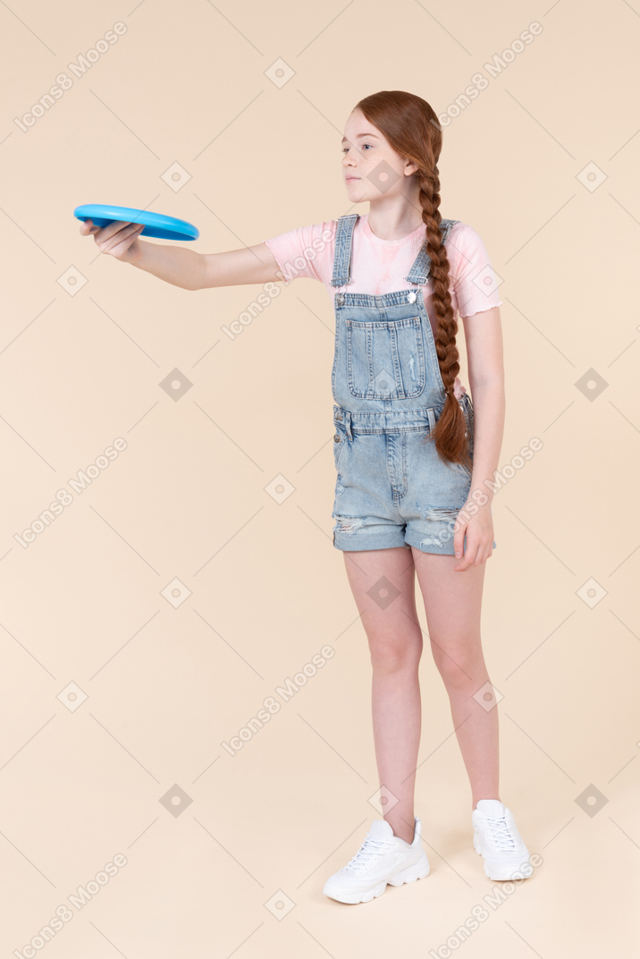 Teenage girl holding frisbee