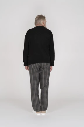 Rear view of old man standing and looking aside