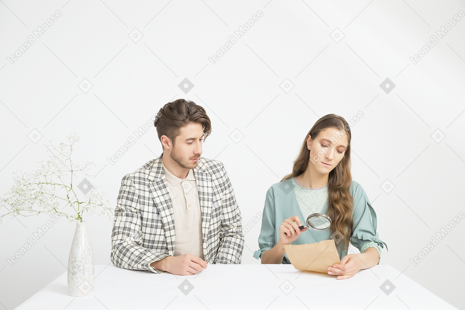 Couple sitting at the table and investigating a paper