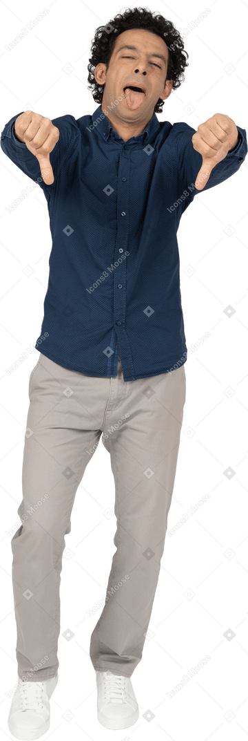 Front view of a man in casual clothes showing thumbs down