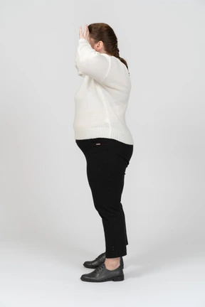 Plump woman in casual clothes standing