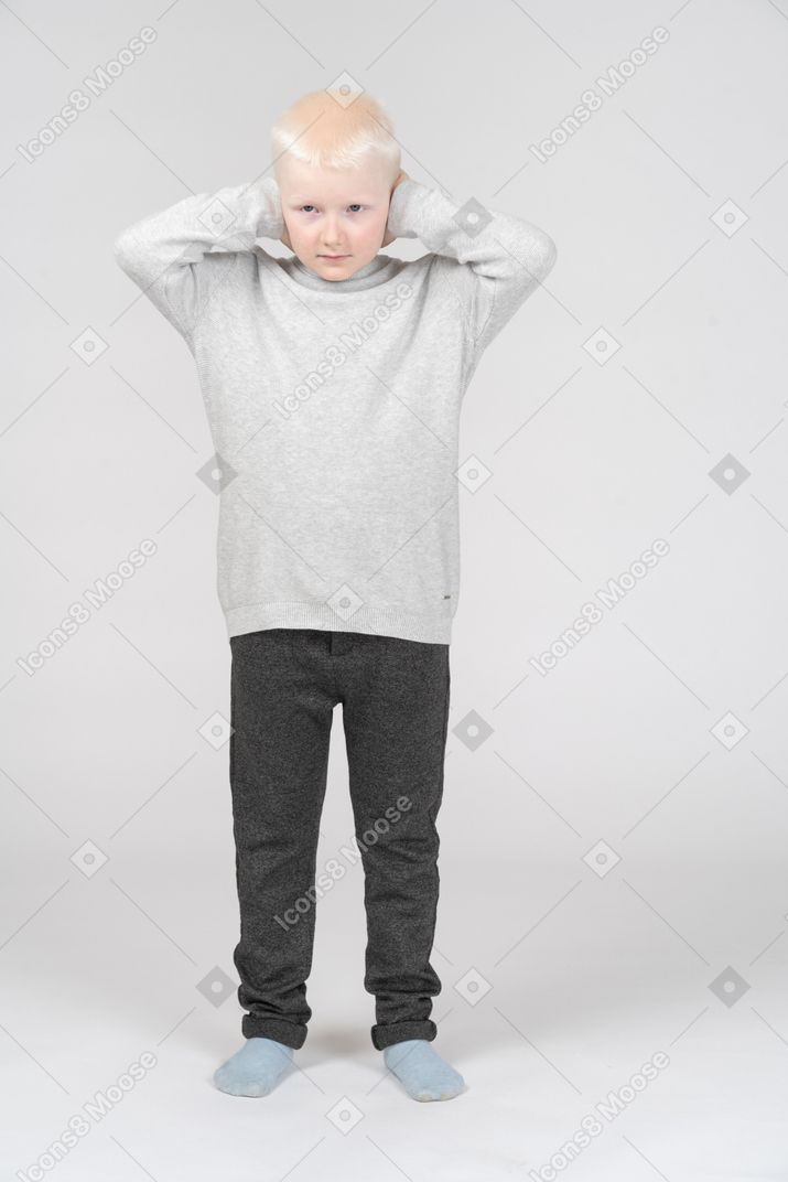 Boy covering his ears with hands