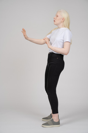 Side view of a young girl extends arms out in front of her