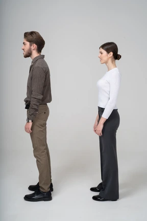 Vista lateral, de, un, pareja joven, en, oficina, ropa, apretar los dientes
