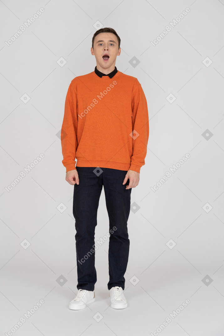 Man in orange sweater stands with open mouth