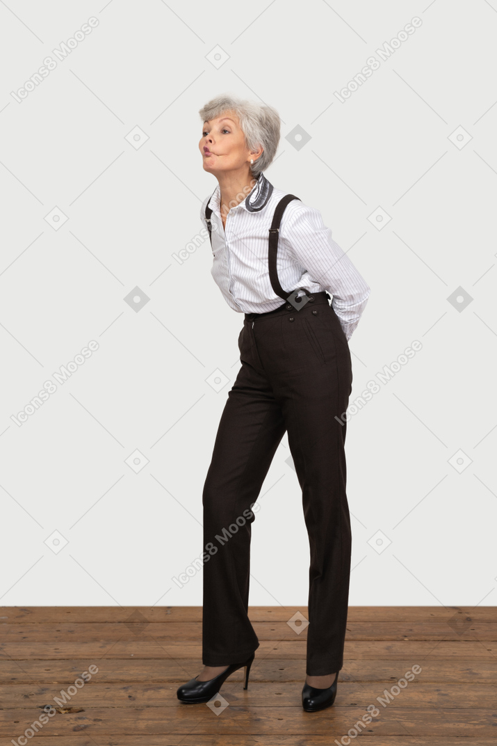 Three-quarter view of a pouting old lady in office clothing